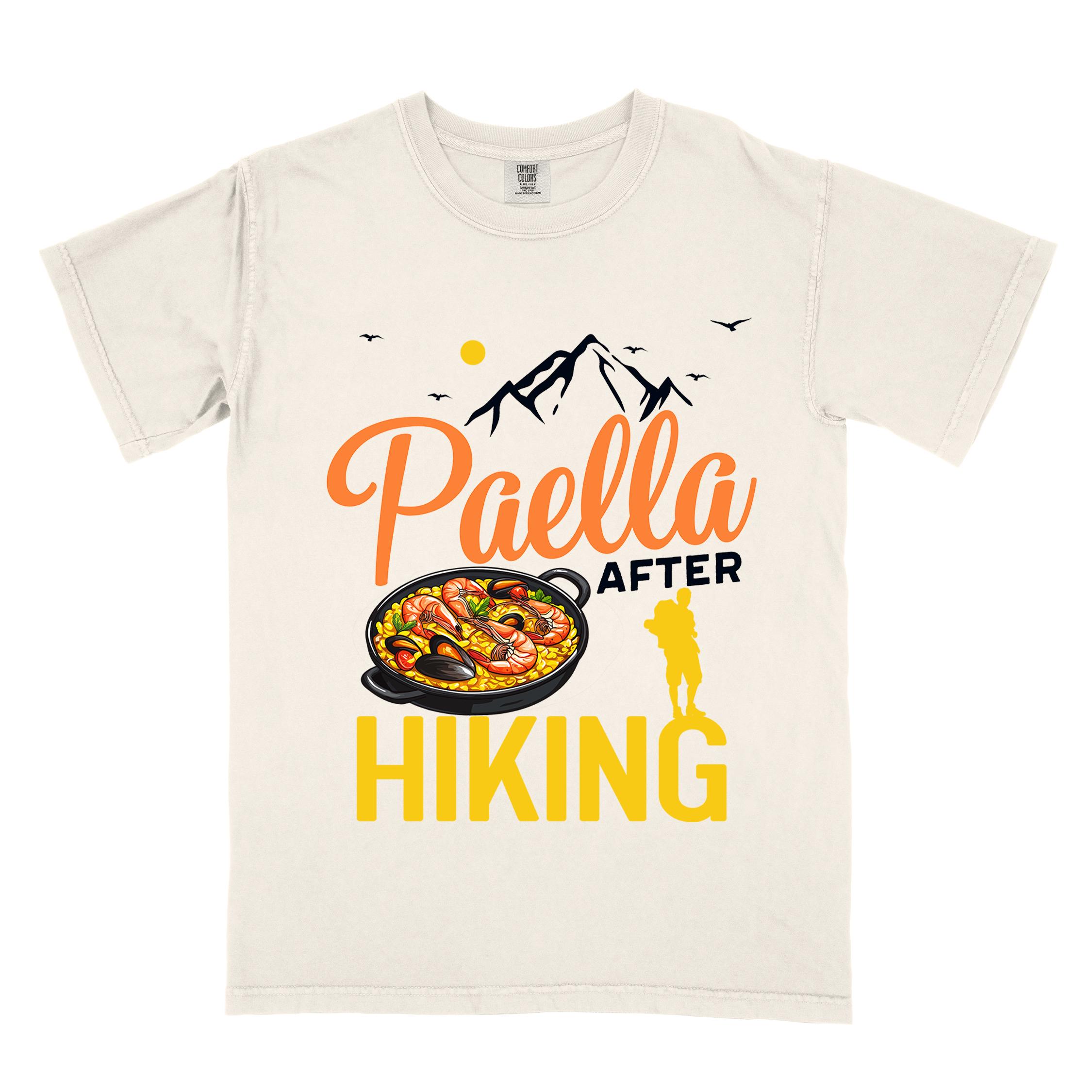 Ivory "Paella after hiking" colored vintage tee with bold typography, mountains, birds, illustrated paella platter, and backpackers for rice lovers.