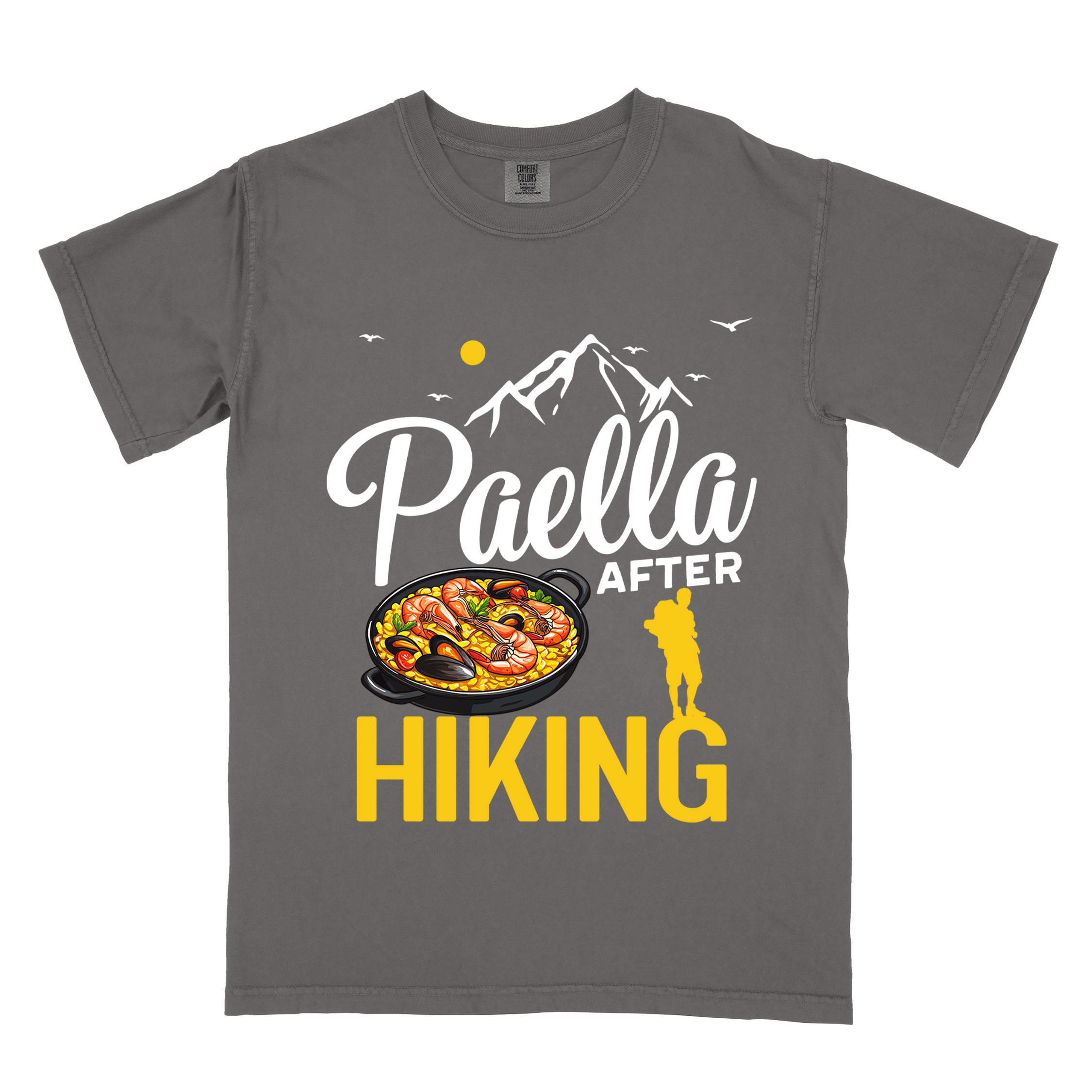Pepper "Paella after hiking" colored vintage tee with bold typography, mountains, birds, illustrated paella platter, and backpackers for rice lovers.