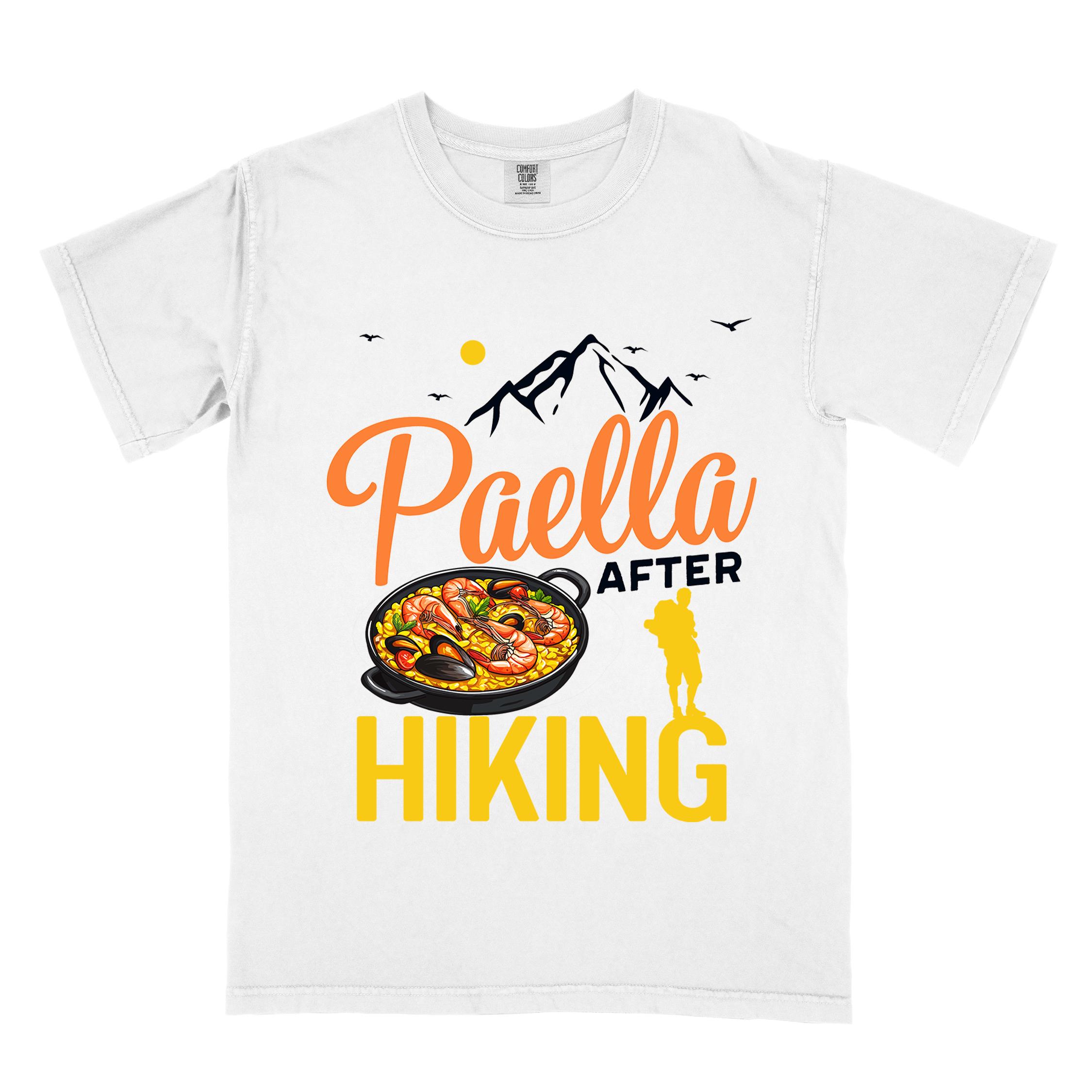 White "Paella after hiking" colored vintage tee with bold typography, mountains, birds, illustrated paella platter, and backpackers for rice lovers.