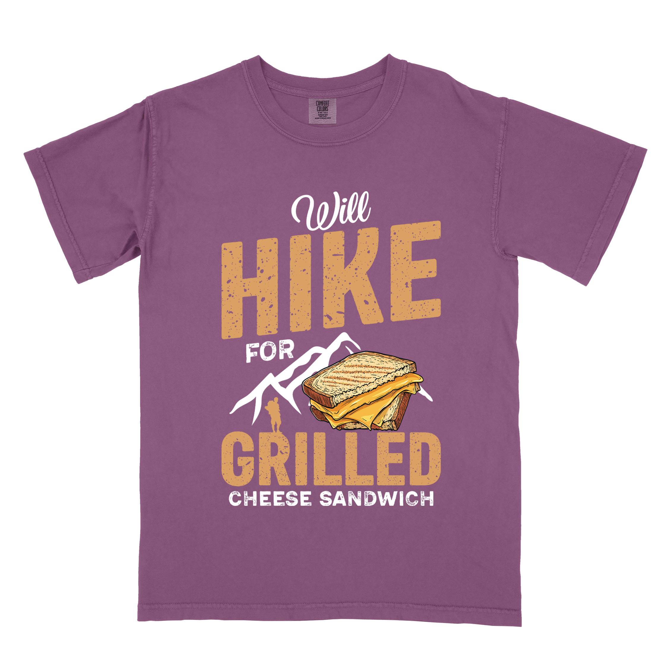 Berry "will hike for grilled cheese sandwich" colored vintage tee with bold typography, mountains, birds, illustrated grilled cheese sandwich, and backpackers for sandwich enthusiasts