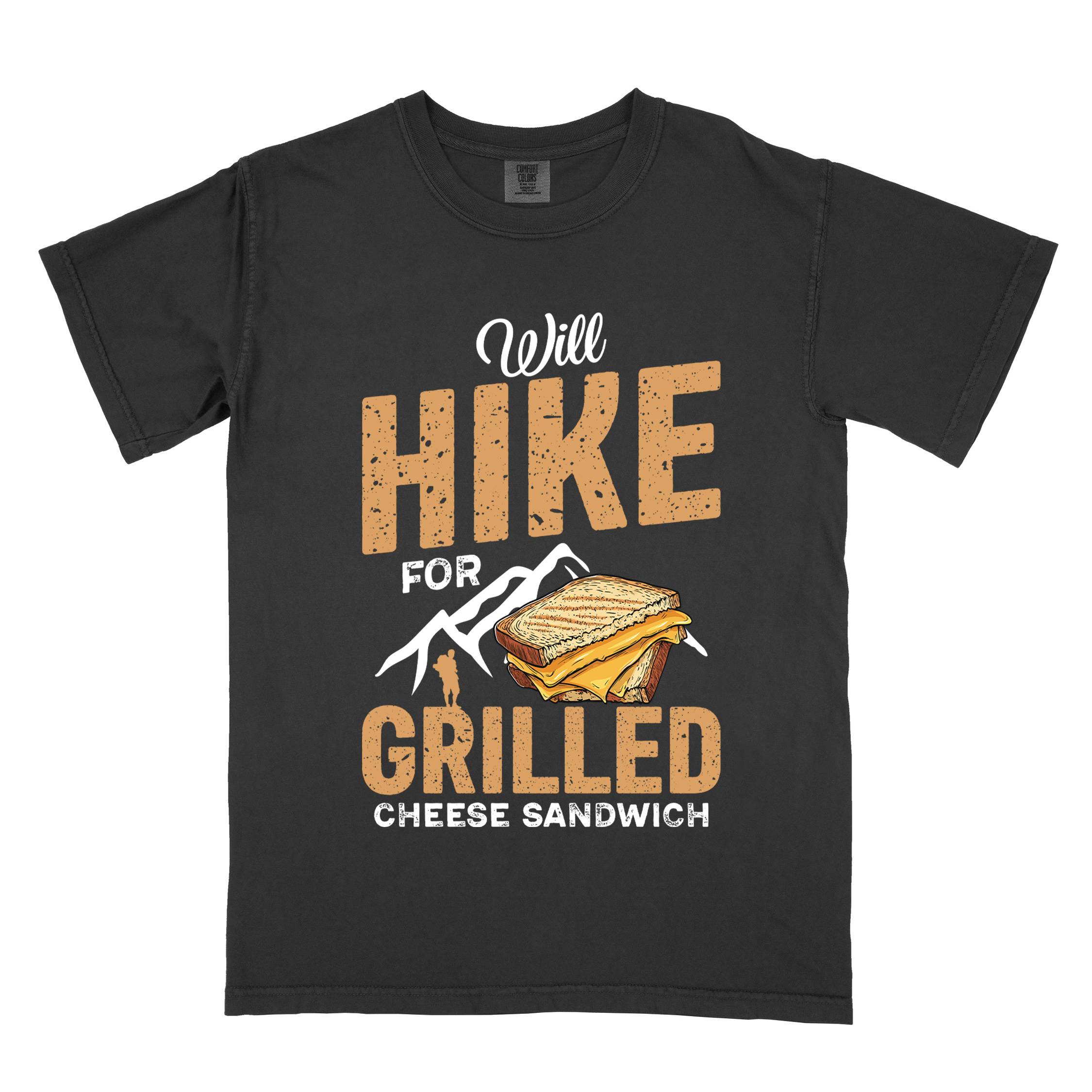 Black "will hike for grilled cheese sandwich" colored vintage tee with bold typography, mountains, birds, illustrated grilled cheese sandwich, and backpackers for sandwich enthusiasts