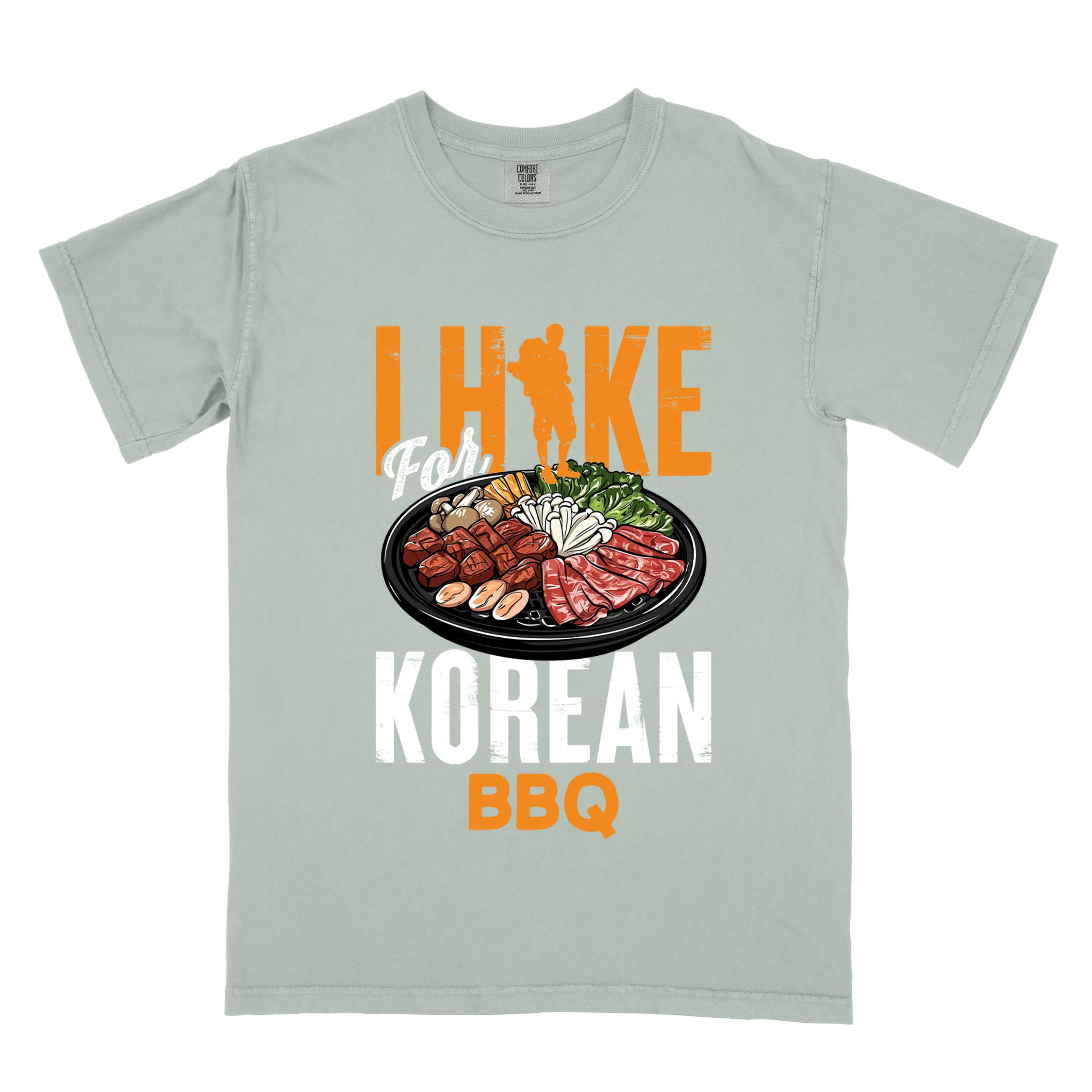 Bay "I hike for korean bbq" colored vintage tee with bold typography, illustrated grilling platter korean bbq, mountains, birds, and backpacker for kbbq lovers.