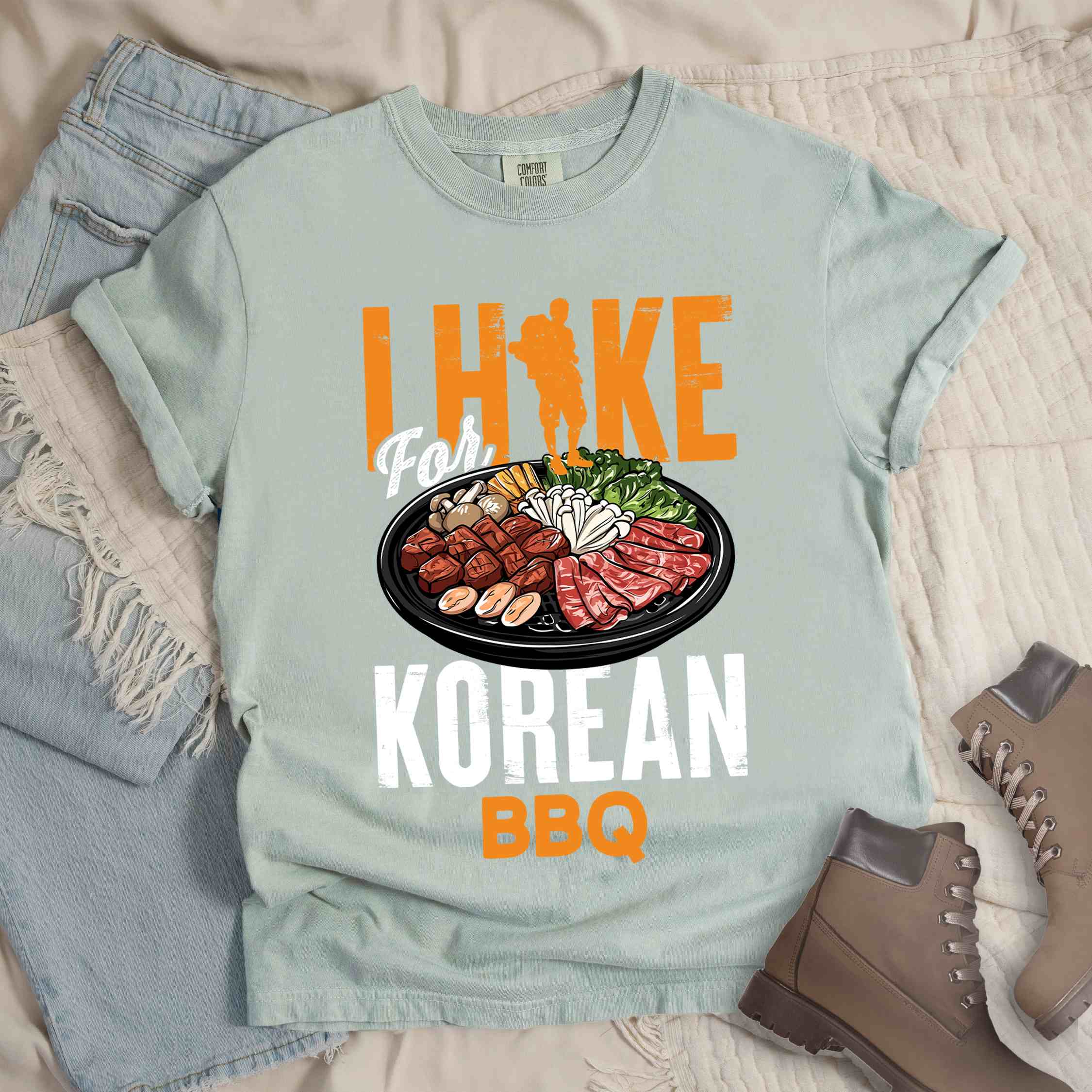 Bay "I hike for korean bbq" colored vintage tee with bold typography, illustrated grilling platter korean bbq, mountains, birds, and backpacker for kbbq lovers.