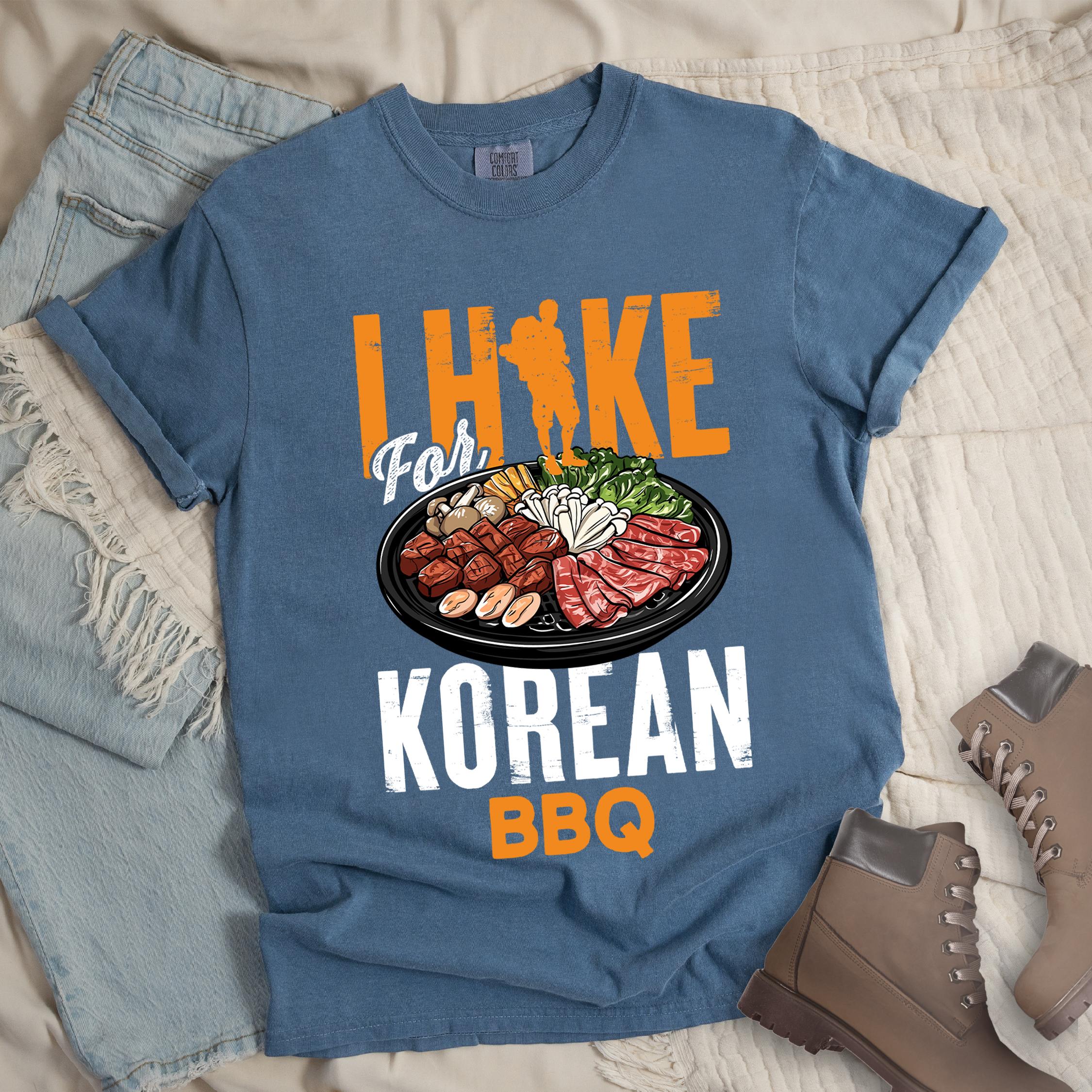 Dark blue shirt with Hiking Design featuring the phrase “I Hike for Korean BBQ” with a hiker silhouette and a platter of Korean barbecue with side dishes.